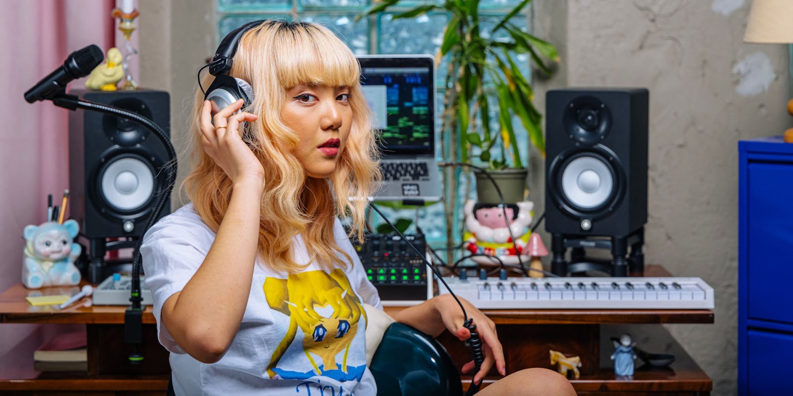 Blonde woman with headphones at her workstation